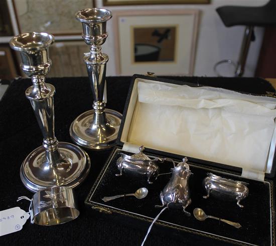 Pair of silver candlesticks (weighted), three-piece silver cruet, cased & an engraved silver napkin ring